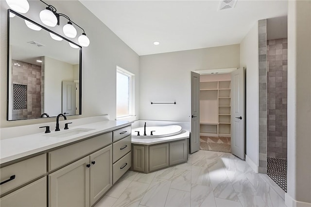 bathroom with vanity and independent shower and bath