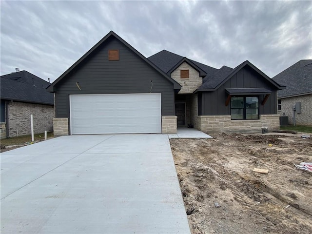 view of front of property with central AC and a garage