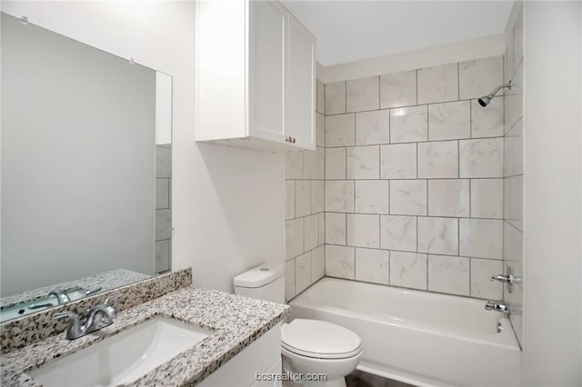 full bathroom featuring vanity, toilet, and tiled shower / bath