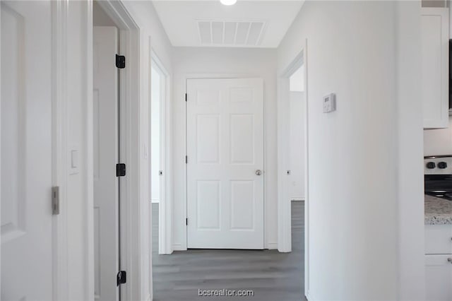 hallway with dark hardwood / wood-style flooring