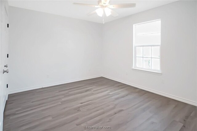 empty room with ceiling fan and wood-type flooring