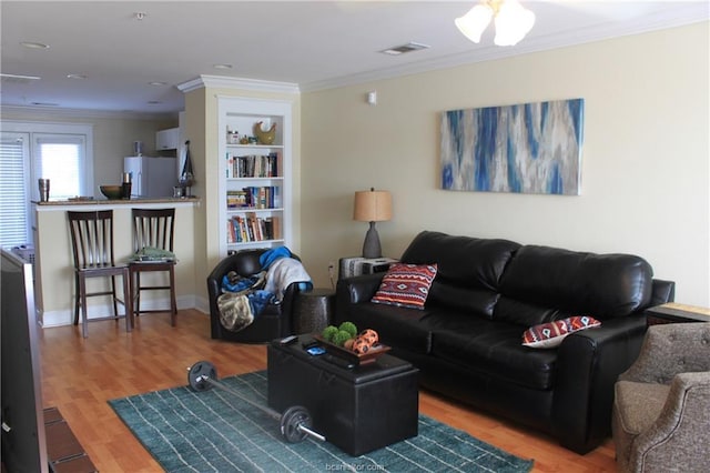 1725 Harvey Mitchell Pkwy S Unit 1724, College Station, TX 77840 - living area featuring crown molding, wood finished floors, and built in features