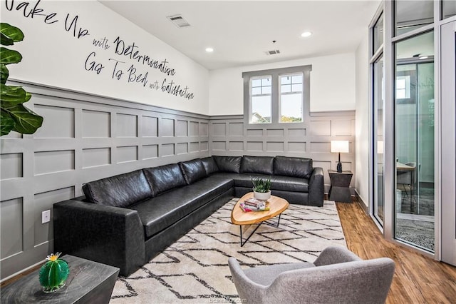1725 Harvey Mitchell Pkwy S Unit 1724, College Station, TX 77840 - living room with a decorative wall, wood finished floors, a wainscoted wall, and recessed lighting