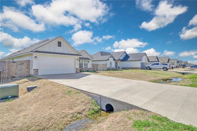 view of front of property with a residential view, board and batten siding, driveway, and fence