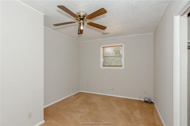 empty room featuring light carpet and ceiling fan