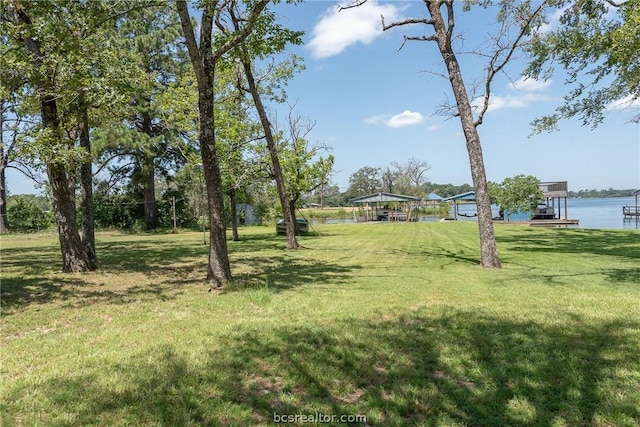 10933 Clyde Accord Rd, Franklin, TX 77856 - view of green lawn featuring a detached carport and a water view