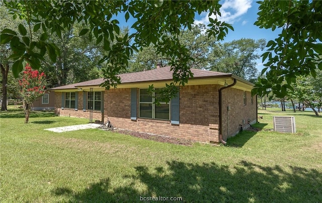 10933 Clyde Accord Rd, Franklin, TX 77856 - back of property featuring brick siding and a yard