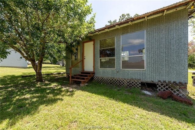 view of property exterior with a lawn