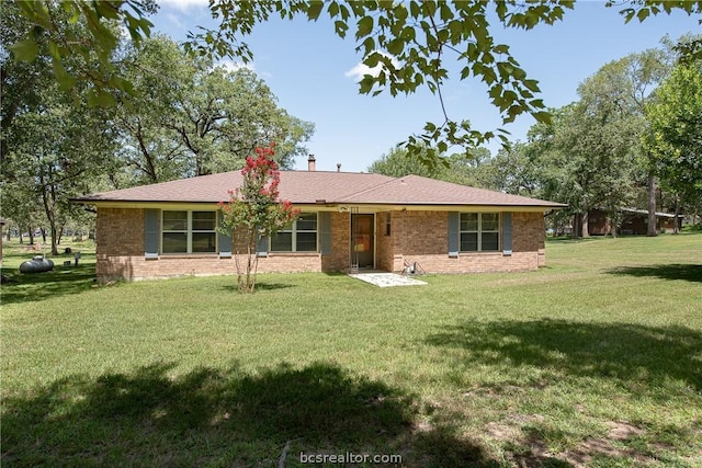 rear view of property with a lawn