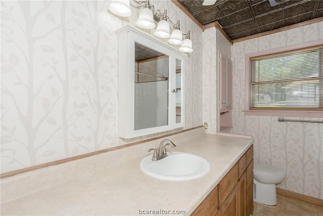 bathroom featuring tile patterned floors, a shower, toilet, vanity, and ornamental molding