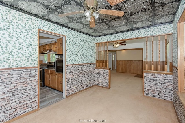 interior space featuring ceiling fan, crown molding, and light carpet