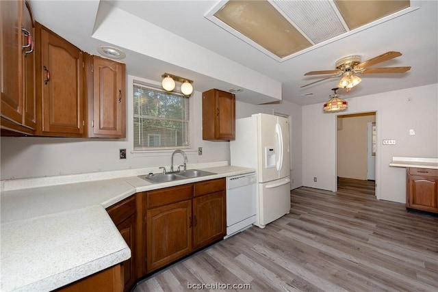 10933 Clyde Accord Rd, Franklin, TX 77856 - kitchen featuring white appliances, light countertops, brown cabinetry, a ceiling fan, and light wood-type flooring