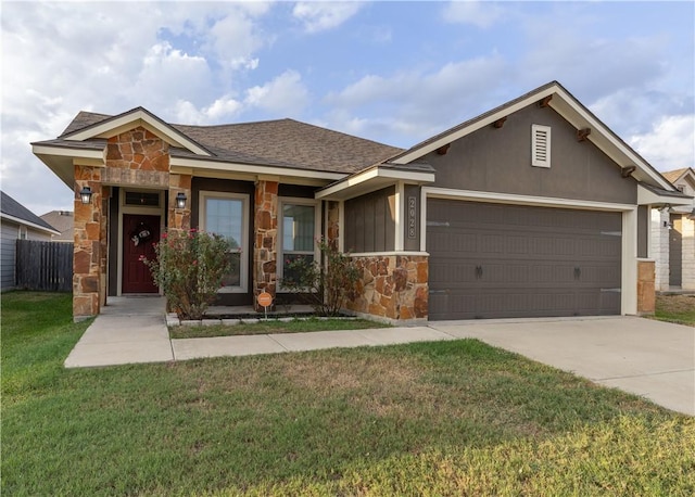 view of front facade featuring a garage, stone siding, driveway, and a front lawn