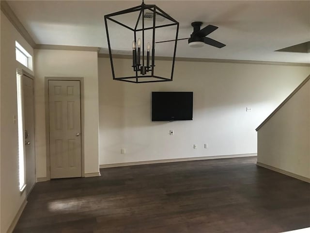 3519 Myth Ln, College Station, TX 77845 - unfurnished living room featuring dark wood-style floors, ornamental molding, baseboards, ceiling fan, and a chandelier