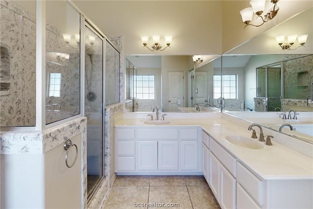 bathroom featuring tile patterned flooring, vanity, and a shower with shower door