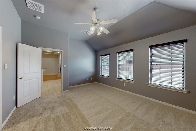 unfurnished bedroom with ceiling fan, light carpet, and vaulted ceiling