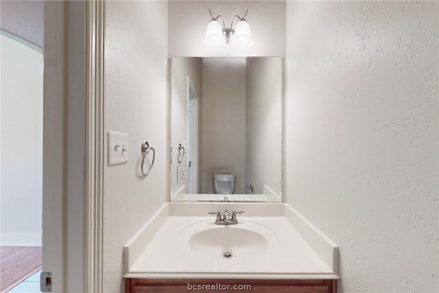 bathroom featuring hardwood / wood-style floors, vanity, and toilet