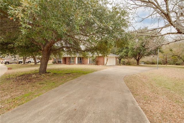 obstructed view of property with a garage and a front yard