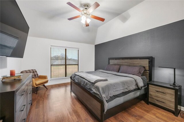 bedroom with dark wood-type flooring, ceiling fan, and lofted ceiling