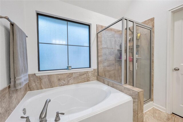 bathroom featuring shower with separate bathtub