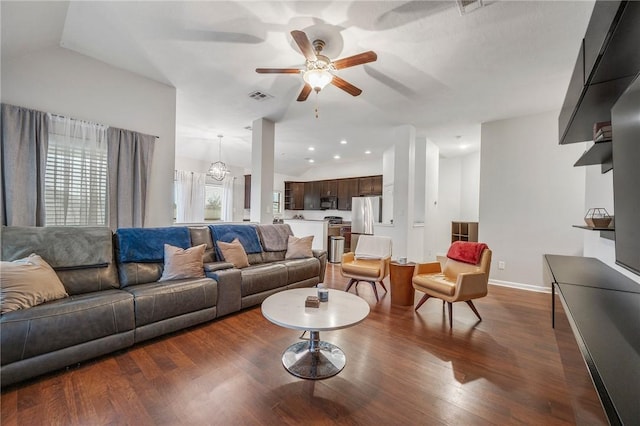 living room featuring dark hardwood / wood-style flooring, vaulted ceiling, and ceiling fan