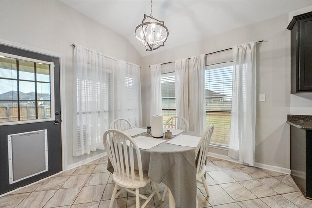 tiled dining space featuring lofted ceiling and a notable chandelier