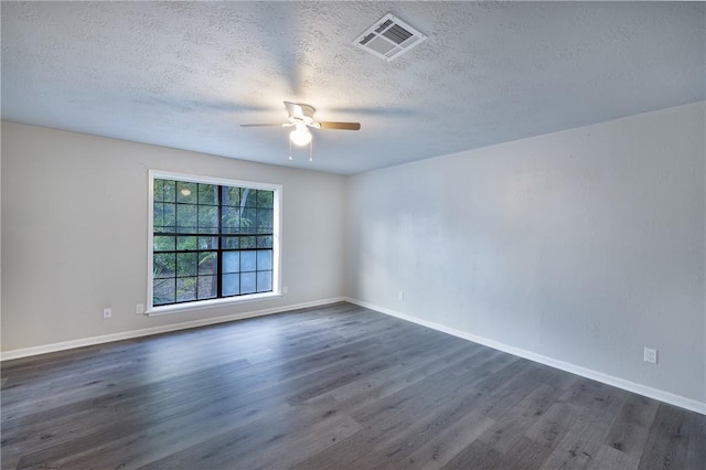 unfurnished room with ceiling fan, dark wood-type flooring, and a textured ceiling