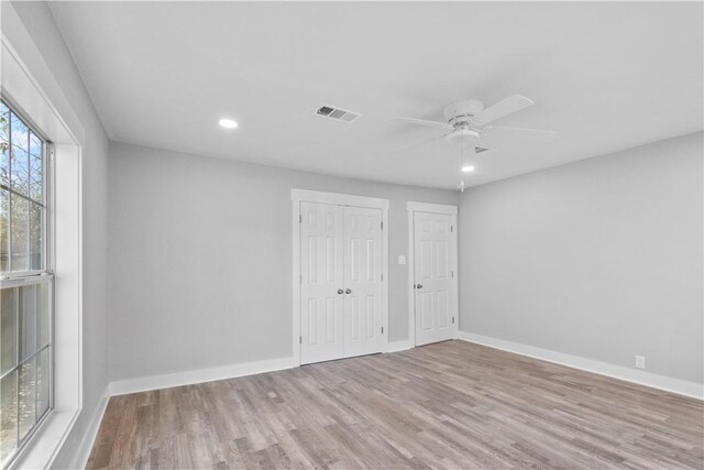 unfurnished bedroom featuring recessed lighting, wood finished floors, visible vents, and baseboards