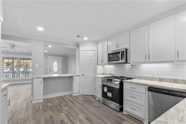 kitchen with visible vents, tasteful backsplash, appliances with stainless steel finishes, and white cabinetry