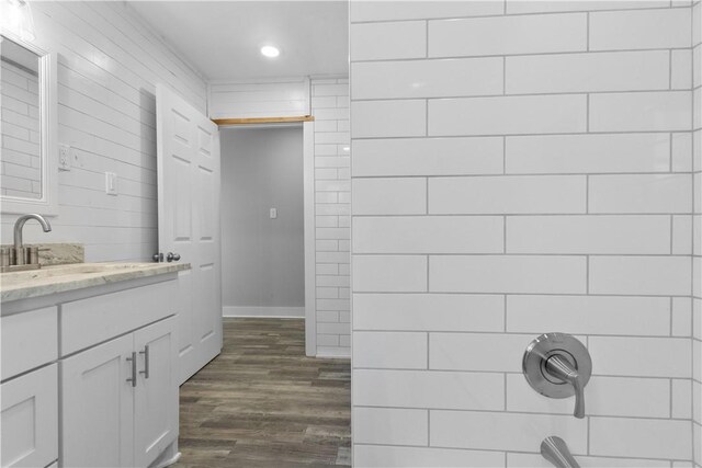 full bath featuring a shower, recessed lighting, wood finished floors, and vanity