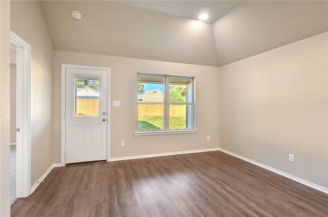 entryway with dark hardwood / wood-style flooring and vaulted ceiling