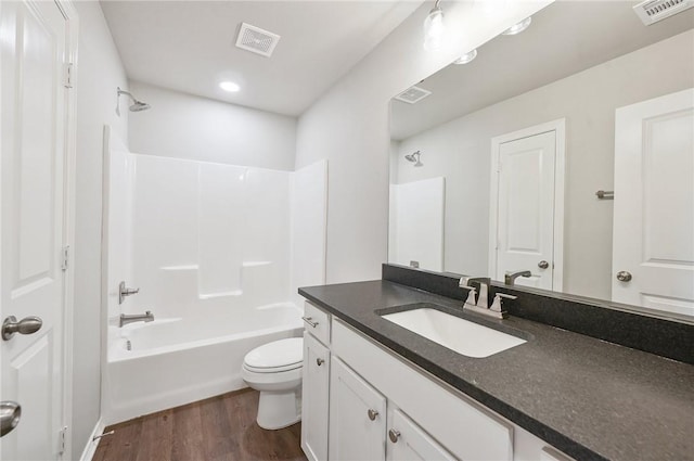 full bathroom with wood-type flooring, vanity, toilet, and tub / shower combination