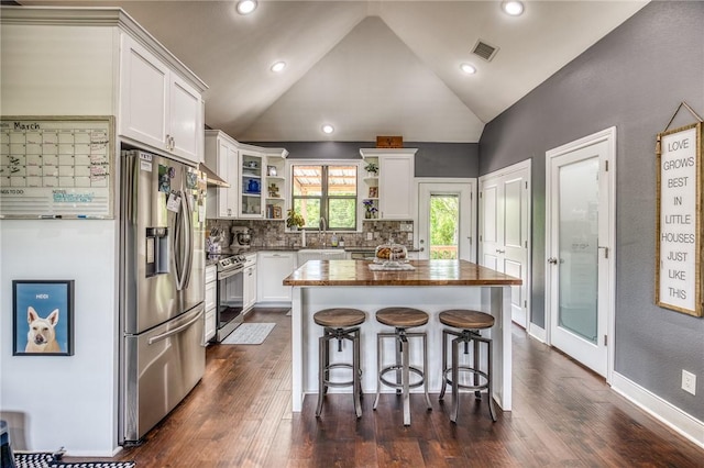 kitchen with wooden counters, a center island, open shelves, white cabinets, and stainless steel appliances