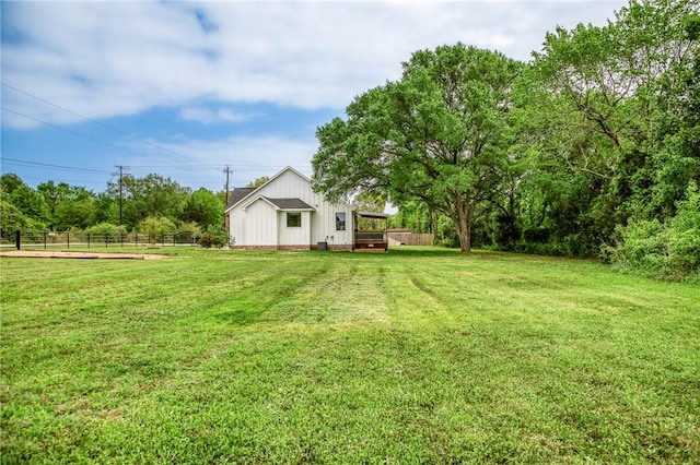 view of yard featuring fence and a wooden deck