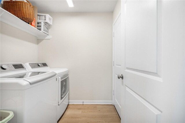 219 Cross Ln, Caldwell, TX 77836 - washroom featuring separate washer and dryer and light wood-style flooring