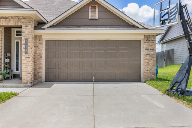 219 Cross Ln, Caldwell, TX 77836 - view of front of house with concrete driveway, brick siding, an attached garage, and roof with shingles
