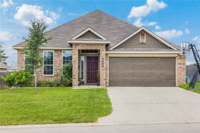219 Cross Ln, Caldwell, TX 77836 - view of front of property featuring a front yard, concrete driveway, an attached garage, and brick siding