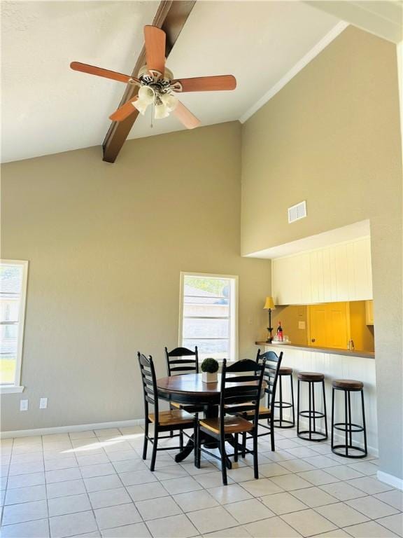 dining space featuring baseboards, plenty of natural light, high vaulted ceiling, and light tile patterned flooring