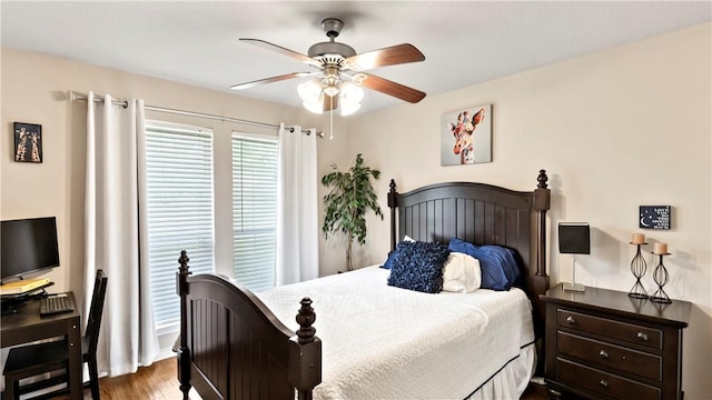 bedroom with a ceiling fan and dark wood finished floors