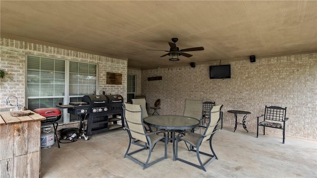 view of patio / terrace with area for grilling, ceiling fan, outdoor dining area, and a sink