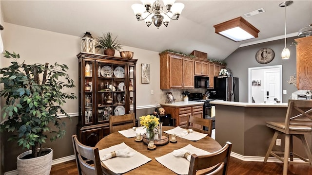 dining room with visible vents, vaulted ceiling, baseboards, a notable chandelier, and dark wood-type flooring