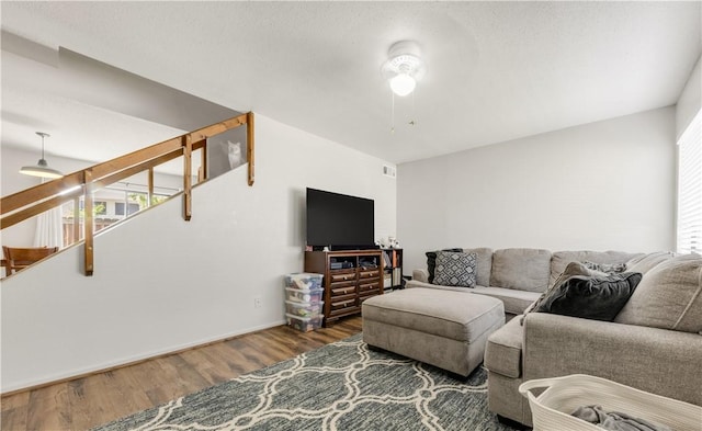 4509 Carter Creek Pkwy Unit 7, Bryan, TX 77802 - living area featuring wood finished floors, ceiling fan, stairway, and baseboards