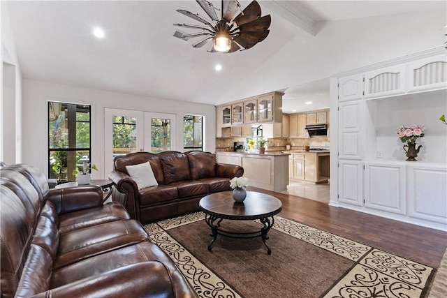 living room featuring lofted ceiling with beams, light hardwood / wood-style floors, ceiling fan, and french doors