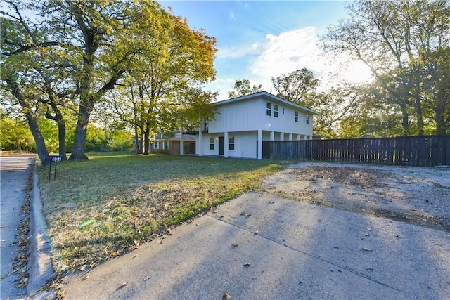 view of side of property with a lawn