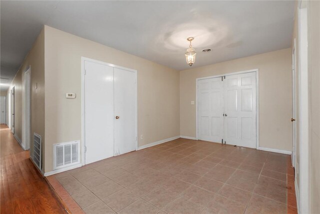 unfurnished bedroom with hardwood / wood-style flooring