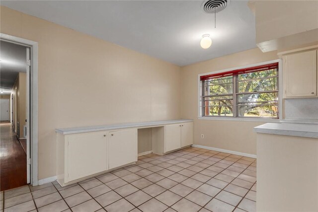 unfurnished dining area featuring light tile patterned floors