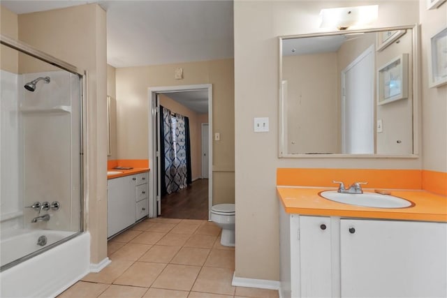 full bathroom with tile patterned floors, vanity, toilet, and enclosed tub / shower combo