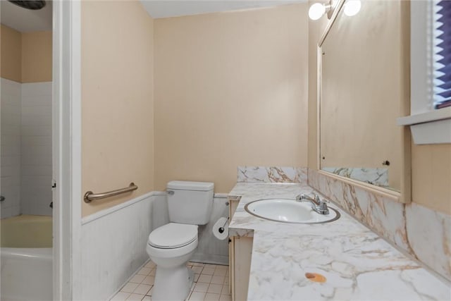 bathroom featuring tile patterned floors, vanity, toilet, and a bathtub