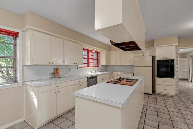 kitchen with light tile patterned floors, stainless steel dishwasher, white refrigerator, black oven, and a kitchen island