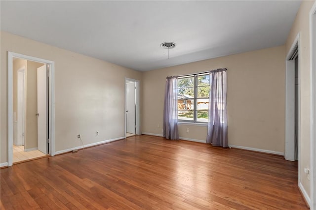 unfurnished bedroom with hardwood / wood-style flooring